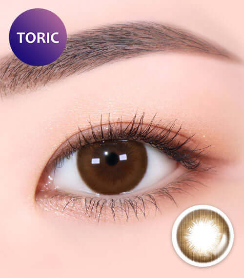 Close-up of eye wearing Danbie Classic Brown toric lens with natural brown color. Suitable for various replacement schedules.