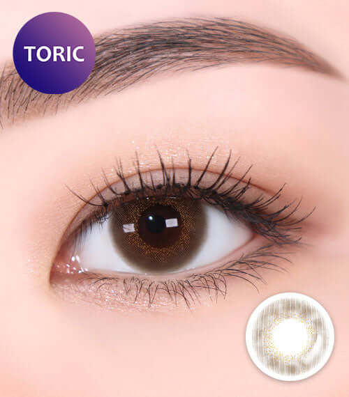 Close-up of an eye wearing Bambi Brown toric contact lenses, showcasing a natural blend with choco color, perfect for various replacement schedules.