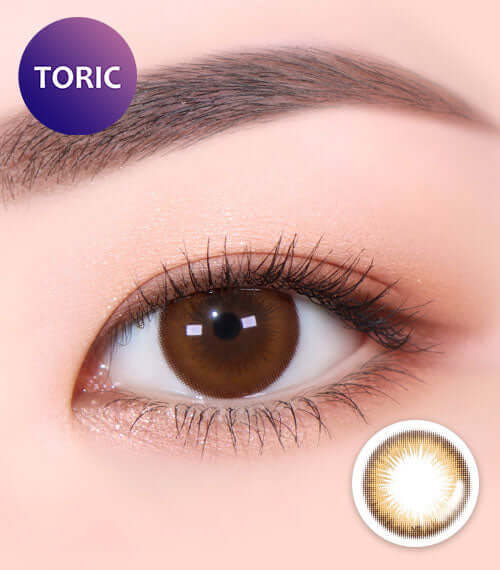 Close-up of eye wearing Aida Hazel toric contact lens with light pigment design and 55% water content for comfortable wear.