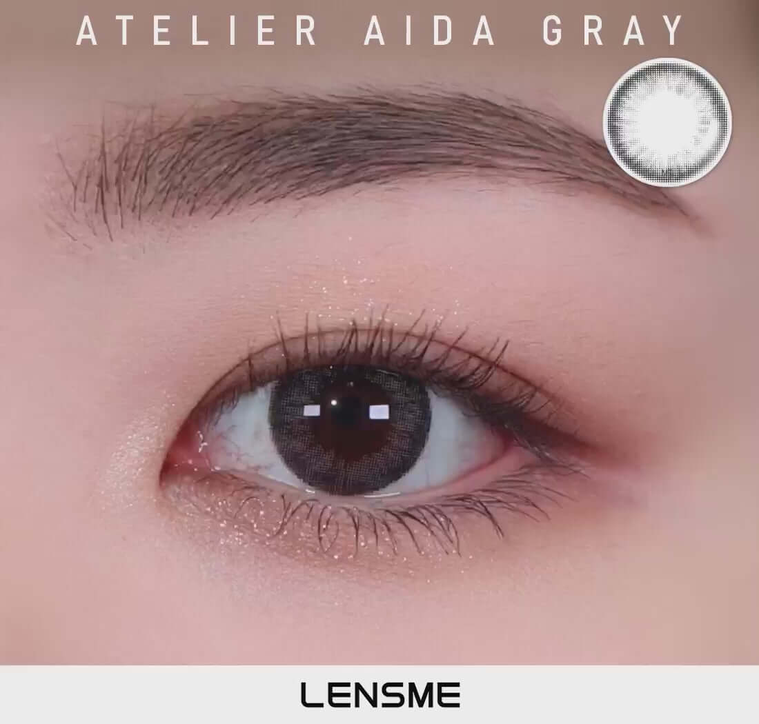 Aida Gray toric contact lens on eye, smokey gray color for glossy, mature look, DIA 14.2, water content 55%, replacement schedule varies.