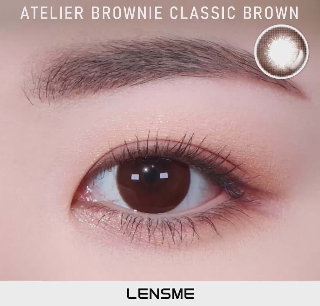 Dark brown toric contact lens enhancing eye appearance, available in daily to yearly replacement schedules. Model: Brownie Classic Brown.