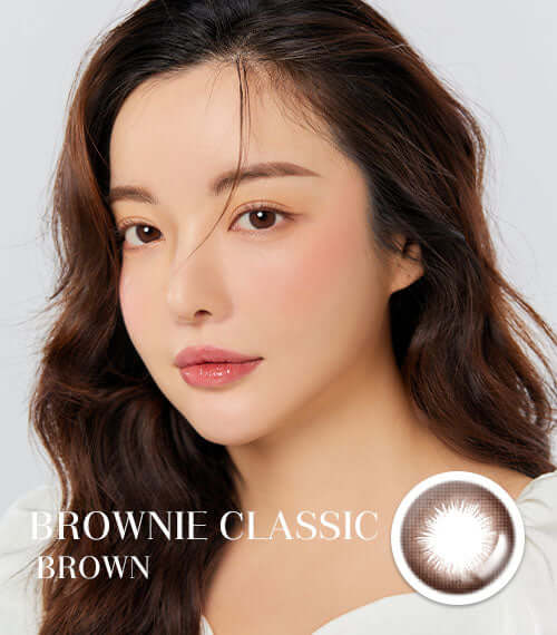 Woman wearing Brownie Classic Brown lenses with dark brown design; toric type; enhances eye size naturally. Product ID: K016CH.